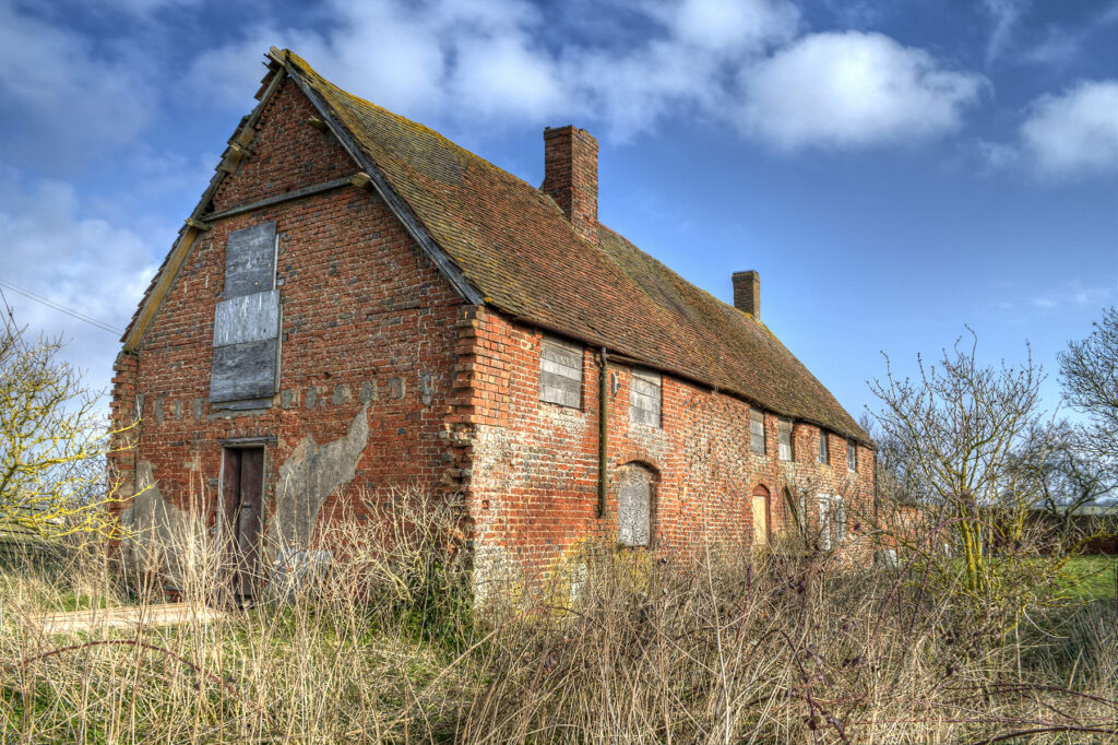 A dilapidated brick built farm building