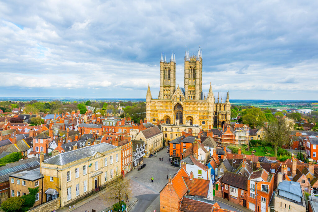 A drone image view of Lincoln taken from the Castle looking towards the cathedral with the countryside in the distance behind