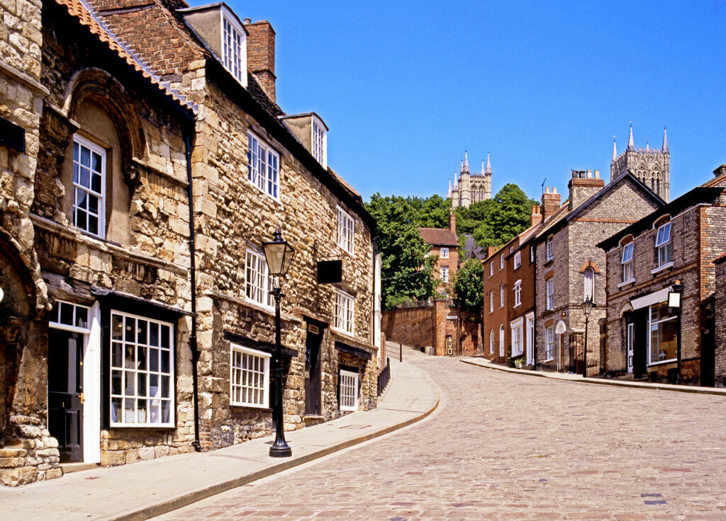 A cobbled street in Lincoln with the Cathedral in the distance